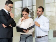 Group of serious business people reading document with important
